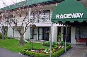 Welcome to Raceway, a charming establishment with a traditional facade and beautifully manicured lawn.